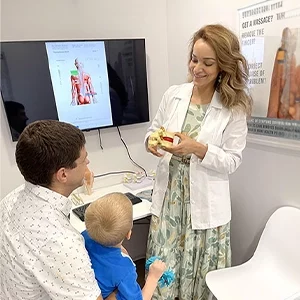 Chiropractor Alexandria VA Monica Jamasi With Pediatric Patient